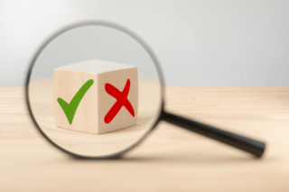 analyze-pros-and-cons-magnifying-glass-with-green-tick-and-red-cross-in-focus-on-wooden-cube-consider-all-arguments-pros-and-cons-choices-tick-yes-or-no-choose-mark-decision